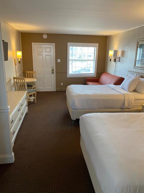double room with two double beds and seating area